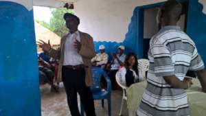M.S. Kamara in discussion with Rochen community