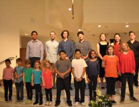 Student Diego proudly poses with ensemble members.