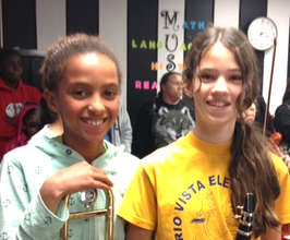 Mae C with her trombone (pictured left)