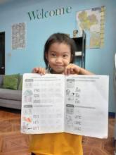 Young Thai Girl Celebrates Penmanship Achievement