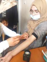 Woman & child receiving healthcare at AfD facility