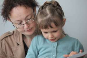 Photo 4. Sonya reads book out loud to her mother