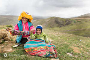 A joyful mother in the bracelet-weaving project.