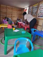 Tinyiko helping them learn the alphabet