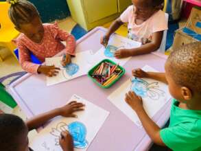 Children coloring their blue hat pictures.