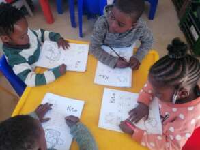 our kids learning how to trace and colour