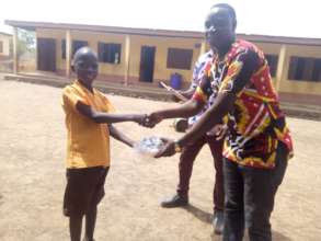 Atta receiving his award from Grameen Ghana staff