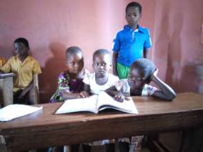 Happy and friends reading in class
