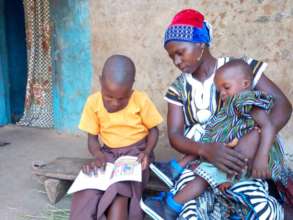 Kitindo reading to her Mother (Lipeenba) at home