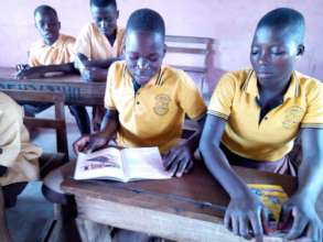 Nnado (boy) reading to Class