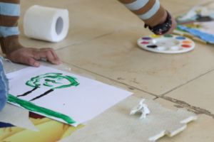 Mostapha painting a picture - Basmeh and Zeitooneh