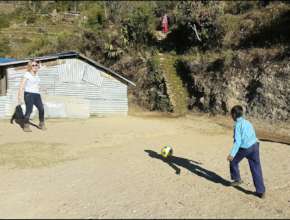 playing football Ms.Paula Nightangale with student