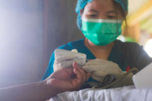 Nurse giving free medical care in remote village
