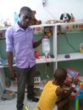 Social Worker holding solute while kid playing