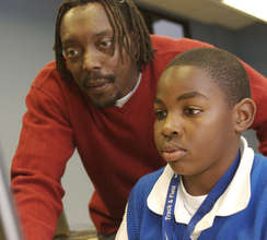 TechStart teacher assists a student