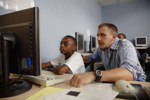 Volunteers help students in the classroom