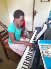 Akena in lesson with Maureen looking on