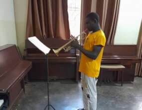 Ian practicing his trumpet