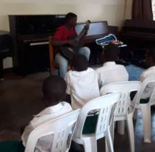 John P performing ,SMK students looking on.