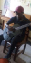 John Paul practising the guitar