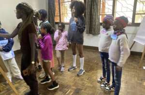 Joy teaching staff notation during the summer camp