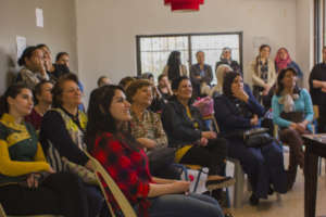 Hope ladies watching assembly of quilt