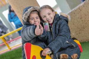 2 girls in Gaza try on their new winter coats
