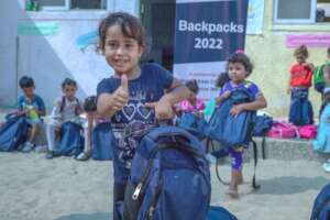 One of 2690 kids in Gaza receiving a new backpack