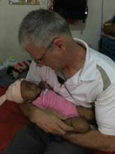 Sgt. Geiger holding baby Azara