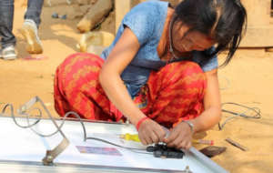 Our solar technician works on a solar panel