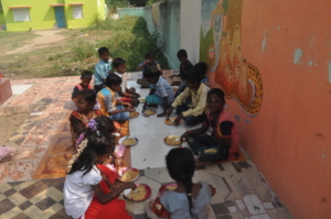 Children happily eating pongal