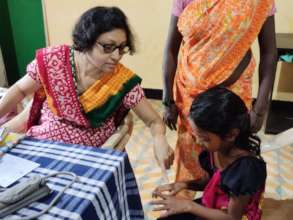 Doctor examining a child hand for skin infection