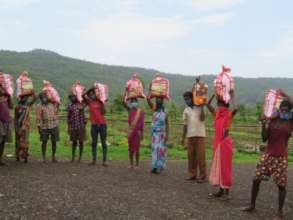Parents with their Food grain and hygiene kit