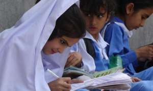 a child girls is writing during class