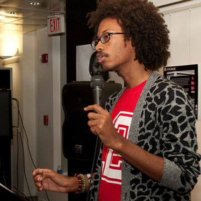 Malik speaking at an exhibit opening