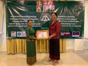 Neak Kru Srey hands out certificates to graduates.