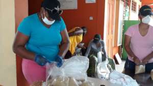 Packing food parcels to distribute to needy