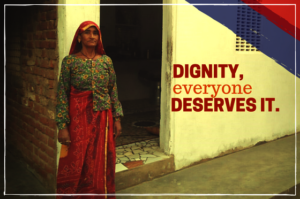 Sita stands in front of her house that was saved