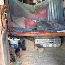 A boy's sleeping space inside the metal workshop