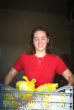 Volunteer with fresh fruit and veg packs