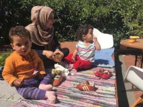 Mother and children enjoying a snack in the sun