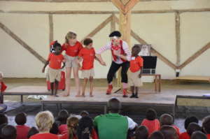 A clown performs during another assembly