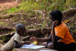 Older sibling working with the little one