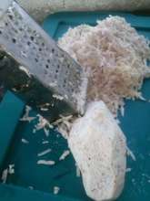 grating yucca to dry into flour