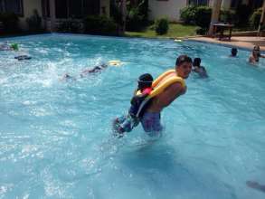 A volunteer helps a child who is afraid of water