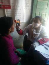COVID-19 - Dr Meena takes a patient's temperature