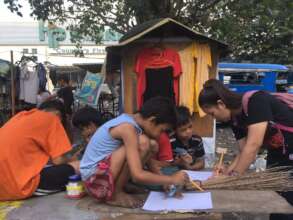 Teaching street children how to write and read.