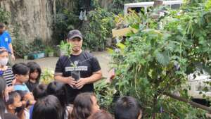 Volunteer teaching street kids on basic planting.