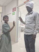Rahul high-fives his father before his surgery