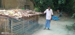 Ummera's father outside their hut